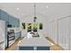 Spacious kitchen with blue cabinets, quartz countertops, stainless steel appliances, and an eat-in island at 1330 Dean St, Charlotte, NC 28216