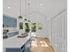 Bright kitchen boasts high ceilings, blue cabinets, white countertops, and a view to the outdoor patio at 1330 Dean St, Charlotte, NC 28216
