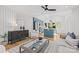 Bright living room featuring modern decor, wood floors, and blue kitchen accents at 1330 Dean St, Charlotte, NC 28216