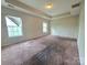 Generous bedroom featuring a tray ceiling and large windows, with carpeted flooring at 13409 Glasgow Green Ln, Charlotte, NC 28213