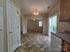 Connected dining area featuring tile flooring and a view into the living area and kitchen at 13409 Glasgow Green Ln, Charlotte, NC 28213
