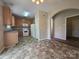 Practical kitchen with wood cabinets, white appliances and tile flooring, ready for a new owner's touch at 13409 Glasgow Green Ln, Charlotte, NC 28213