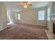 Spacious living room featuring a fireplace, carpet flooring, and natural light from multiple windows at 13409 Glasgow Green Ln, Charlotte, NC 28213