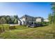 Large backyard with a wooden fence, a deck with pergola, and solar panels on the house at 139 Autumn Grove Ln, Mooresville, NC 28115