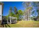 Expansive backyard featuring a pergola-covered deck, playground, and mature trees, perfect for outdoor enjoyment at 139 Autumn Grove Ln, Mooresville, NC 28115