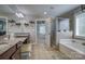 Granite topped double vanity with soaking tub and walk in glass shower at 139 Autumn Grove Ln, Mooresville, NC 28115