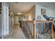 Upstairs hallway with wood railing, neutral paint and carpet, and decorative picture frames, offering a welcoming space at 139 Autumn Grove Ln, Mooresville, NC 28115