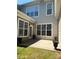 Exterior view of backyard, patio, windows and door, accented by small garden pots at 14208 Castle Abbey Ln, Charlotte, NC 28277