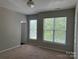 Carpeted bedroom with two large windows providing plenty of natural light at 14208 Castle Abbey Ln, Charlotte, NC 28277