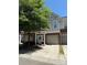 Townhome with a one-car garage and a charming entrance with a wreath-decorated door at 14208 Castle Abbey Ln, Charlotte, NC 28277