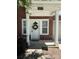 Close-up of a townhouse front door adorned with a wreath, surrounded by brick and white trim at 14208 Castle Abbey Ln, Charlotte, NC 28277