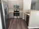 Contemporary kitchen featuring stainless steel appliances and a view into the adjacent dining space at 14208 Castle Abbey Ln, Charlotte, NC 28277