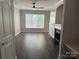 Cozy living space offering a fireplace, ceiling fan and natural light at 14208 Castle Abbey Ln, Charlotte, NC 28277