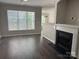 Bright living room showcasing a fireplace, large window and modern flooring at 14208 Castle Abbey Ln, Charlotte, NC 28277