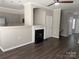 Open-concept space with a fireplace and seamless transition to the kitchen at 14208 Castle Abbey Ln, Charlotte, NC 28277