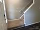 Carpeted staircase with white handrail, leading to the upper level of the home at 14208 Castle Abbey Ln, Charlotte, NC 28277