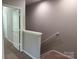 Carpeted staircase leading up, visible from a hallway with white trim at 14208 Castle Abbey Ln, Charlotte, NC 28277