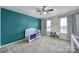 Charming bedroom featuring a ceiling fan, natural light, and colorful decor at 1717 Mill Creek Sw Ln, Concord, NC 28025