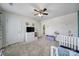 Cozy bedroom featuring a ceiling fan, natural light, and playful decor at 1717 Mill Creek Sw Ln, Concord, NC 28025