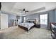 Main bedroom boasts trey ceiling, fan, windows, and a vanity at 1717 Mill Creek Sw Ln, Concord, NC 28025
