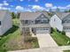 Traditional home with a gray exterior, well-kept lawn and landscaping at 1717 Mill Creek Sw Ln, Concord, NC 28025