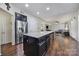 Open kitchen design with an island, flowing into the adjacent living area, perfect for entertaining at 1717 Mill Creek Sw Ln, Concord, NC 28025