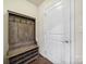 Convenient mudroom entryway featuring a coat rack, bench, and shoe storage for organization at 1717 Mill Creek Sw Ln, Concord, NC 28025