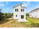 A shot of the backyard featuring a concrete patio and sliding glass door of the two-story white home at 2043 Greenoak Dr, Shelby, NC 28152
