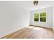 Light bedroom with a large window, wood-look flooring, and minimalist decor at 2043 Greenoak Dr, Shelby, NC 28152