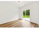 Bright room with wood-look flooring, sliding glass doors, and backyard access at 2043 Greenoak Dr, Shelby, NC 28152