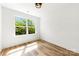 Bright bedroom featuring wood-look floors and a large window offering backyard views at 2043 Greenoak Dr, Shelby, NC 28152