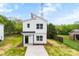 A modern two-story home with white siding, a black front door, and a minimalist design at 2043 Greenoak Dr, Shelby, NC 28152