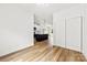 Open living space with modern kitchen, wood-look floors, white walls, and natural light at 2043 Greenoak Dr, Shelby, NC 28152