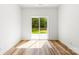 Room featuring a sliding glass door leading to the outside and wood laminate flooring at 2043 Greenoak Dr, Shelby, NC 28152