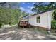 Charming backyard featuring a wooden deck, vibrant landscaping, and a well-maintained lawn, perfect for outdoor enjoyment at 216 W 16Th St, Kannapolis, NC 28081