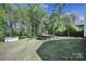 Spacious backyard with a pool, providing a relaxing outdoor space with lush greenery and a storage shed at 216 W 16Th St, Kannapolis, NC 28081