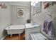 Bathroom featuring a claw foot tub, single sink vanity, and fun animal decorations at 216 W 16Th St, Kannapolis, NC 28081