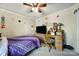 Bedroom featuring a wooden desk, television on a dresser, and a bed with a purple comforter at 216 W 16Th St, Kannapolis, NC 28081
