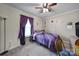 Cozy bedroom with a purple comforter on a twin bed beneath a window with dark purple curtains at 216 W 16Th St, Kannapolis, NC 28081
