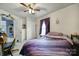 Cozy bedroom with a purple comforter on a bed beneath a window with dark purple curtains at 216 W 16Th St, Kannapolis, NC 28081