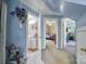 Hallway showing access to rooms and bathroom with blue walls, carpeted floor and hanging flower decoration at 216 W 16Th St, Kannapolis, NC 28081