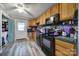 Charming kitchen featuring black appliances, warm wood cabinets, and a convenient door to the exterior at 216 W 16Th St, Kannapolis, NC 28081