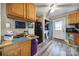 Well-appointed kitchen with dark appliances, wood cabinets, adjacent pantry, and outside access at 216 W 16Th St, Kannapolis, NC 28081