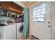 The laundry room features a washer, dryer, storage cabinets, and a door to the exterior at 216 W 16Th St, Kannapolis, NC 28081