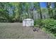 Well-maintained storage shed nestled among trees, providing ample space for gardening tools and outdoor equipment at 216 W 16Th St, Kannapolis, NC 28081