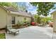 Landscaped backyard with a lounge chair and a stone bench beneath mature trees at 2234 Hamilton Mill Rd, Charlotte, NC 28270