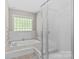 Bright bathroom featuring a glass shower and a large soaking tub at 2234 Hamilton Mill Rd, Charlotte, NC 28270