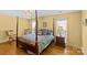 Bedroom featuring a four poster bed, hardwood floors, and a view from the windows at 2234 Hamilton Mill Rd, Charlotte, NC 28270