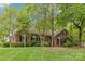 Attractive brick home with lush landscaping, mature trees, and a well-maintained lawn at 2234 Hamilton Mill Rd, Charlotte, NC 28270