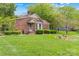 Quaint brick home with a well-manicured lawn and charming landscaping at 2234 Hamilton Mill Rd, Charlotte, NC 28270